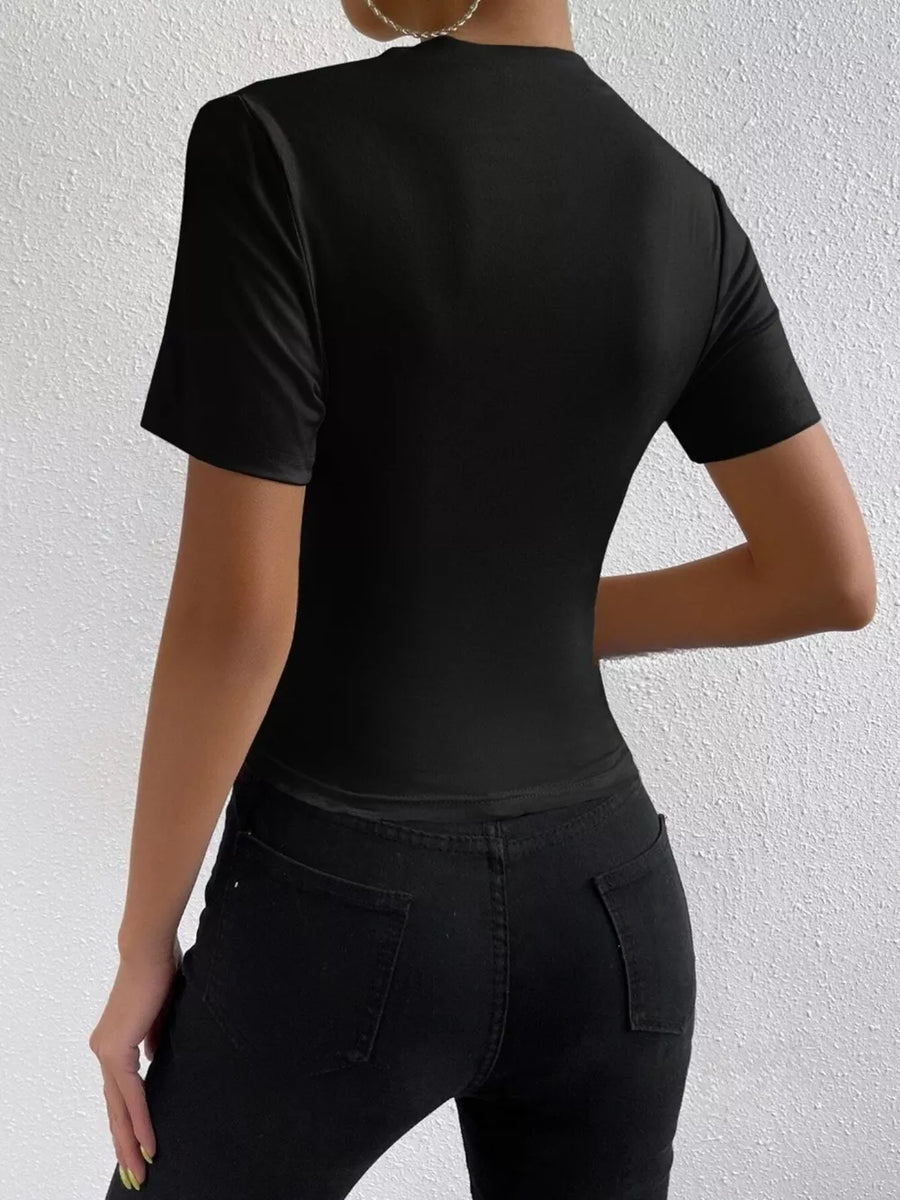 Black ruched mock neck t-shirt with short sleeves, draped fit.