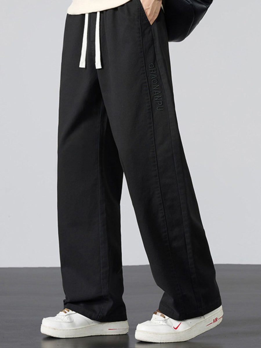 Men's Plus Size Pocketed Drawstring Wide Leg Pants in Black with drawstring waist