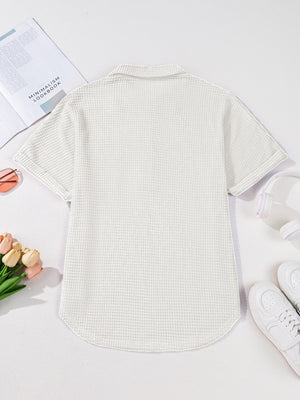 White waffle knit button-up shirt with short sleeves and a collared neckline.