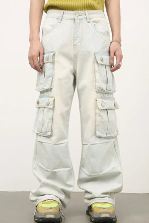 Light wash denim cargo pants with multiple pleated pockets and wide legs.