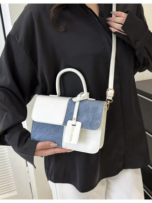Chic two-tone PU leather crossbody bag with white and blue panels and a top handle.