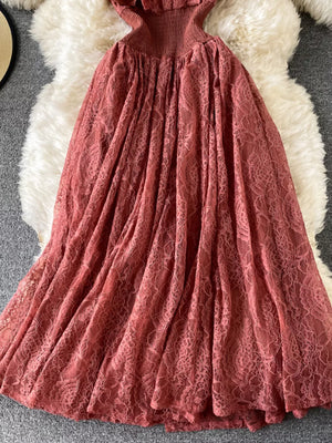Elegant ruffled lace maxi dress in a dusty rose pink with a smocked bodice and full skirt.