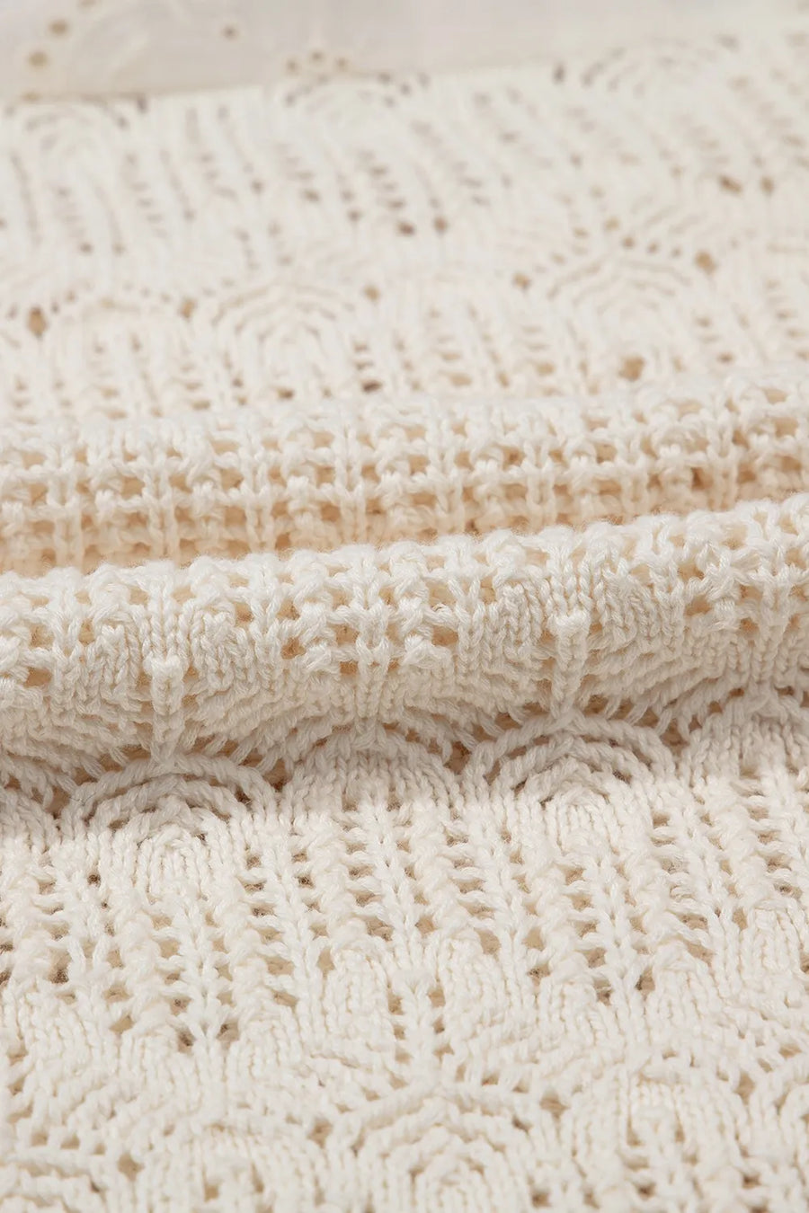 Beige crochet knit vest with eyelet yoke detail and open knit pattern.