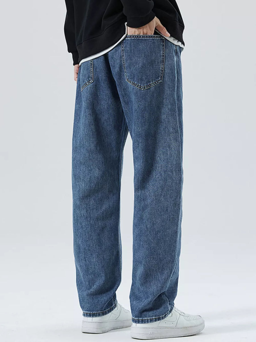 Men's light blue 100% cotton loose-fit jeans with drawstring detail and classic back pockets.