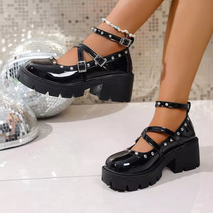 Black patent platform Mary Jane sneakers with studded straps and buckles.