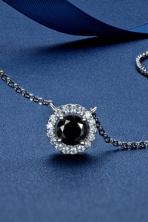 Black halo moissanite necklace with a round black center stone and clear accent stones on a silver chain.