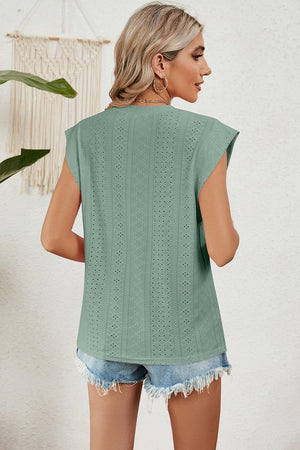 Light green perforated shoulder-pad top with cap sleeves and a textured pattern.
