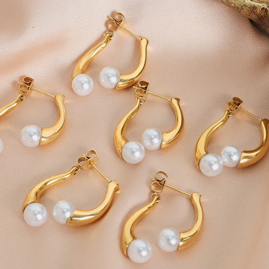 Gold sculptural drop hoop earrings with pearls