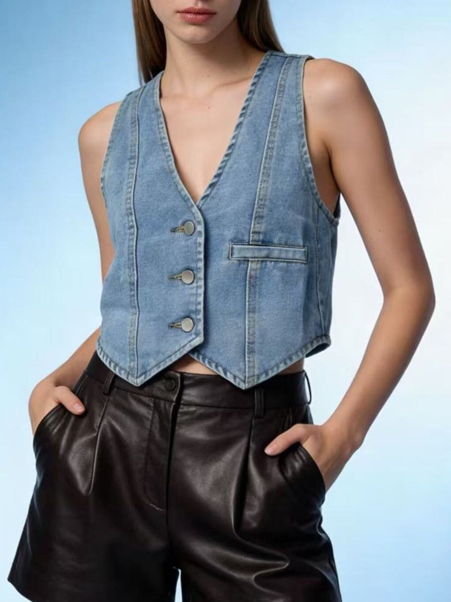 Light blue denim vest with button front and pocket detail