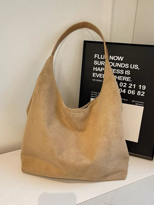 Khaki suede hobo bag with a single strap and slouchy silhouette.