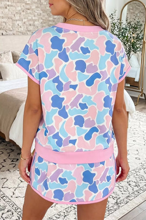 Pastel camouflage athletic two-piece set with crew neck top and shorts.