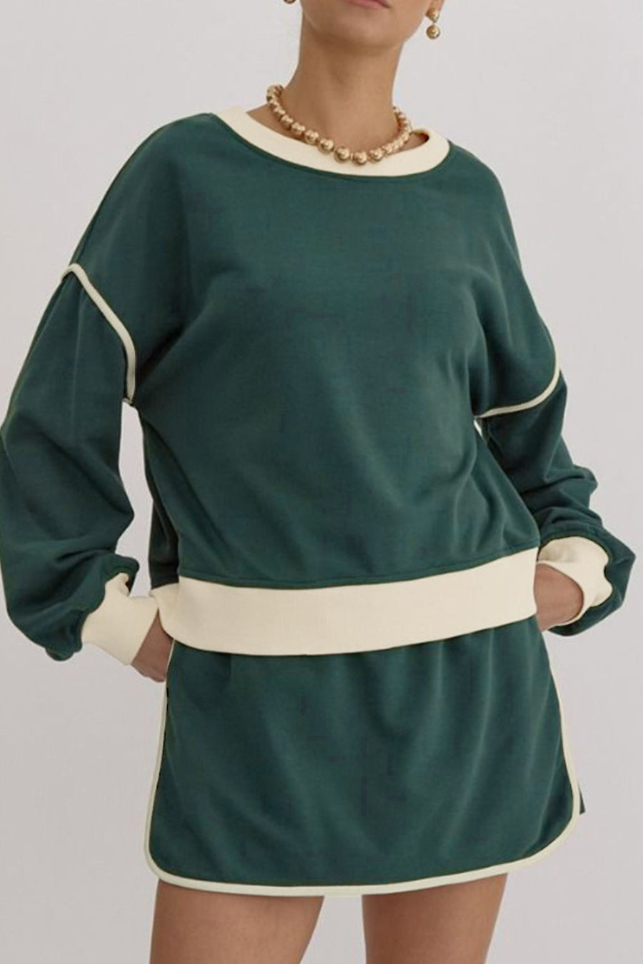 Dark green sweatshirt and skort set with cream contrast trim and neckline.