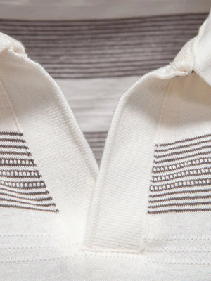 Ivory polo shirt with textured horizontal stripe detail on collar and chest.