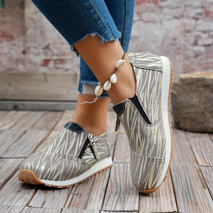 Zebra print slip-on flats in grey with side zippers and a comfortable sole.