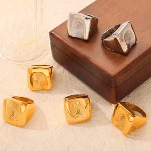 Sculpted fingerprint signet rings in silver and gold with a unique bioprint design.