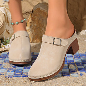 Beige round toe platform slip-ons with buckle detail and chunky heel.