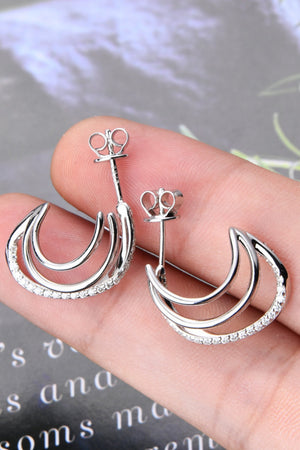 Silver triple hoop diamond stud earrings with a crescent shape and pavé diamond accents.