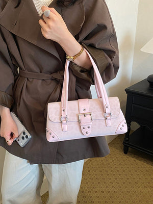 Brown shoulder bag featuring buckle detail and leopard