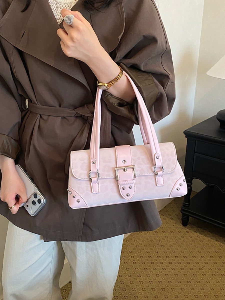 Brown shoulder bag featuring buckle detail and leopard