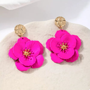 gold earrings featuring drop design and floral