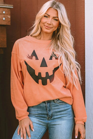 Caramel corduroy sweatshirt with a black jack-o'-lantern graphic and long sleeves.