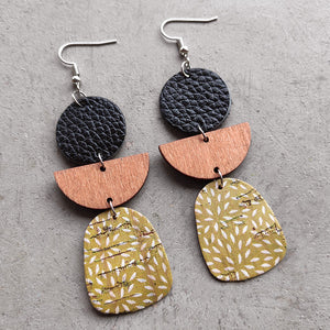 Black, wood, and patterned dangle earrings with geometric shapes