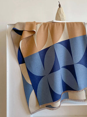 Geometric patterned soft scarf in blue and tan with fringe details