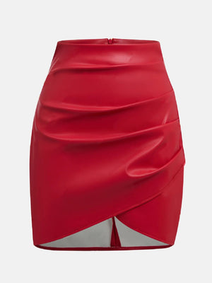 Scarlet faux leather mini skirt with asymmetrical draped detail and wrap hem.