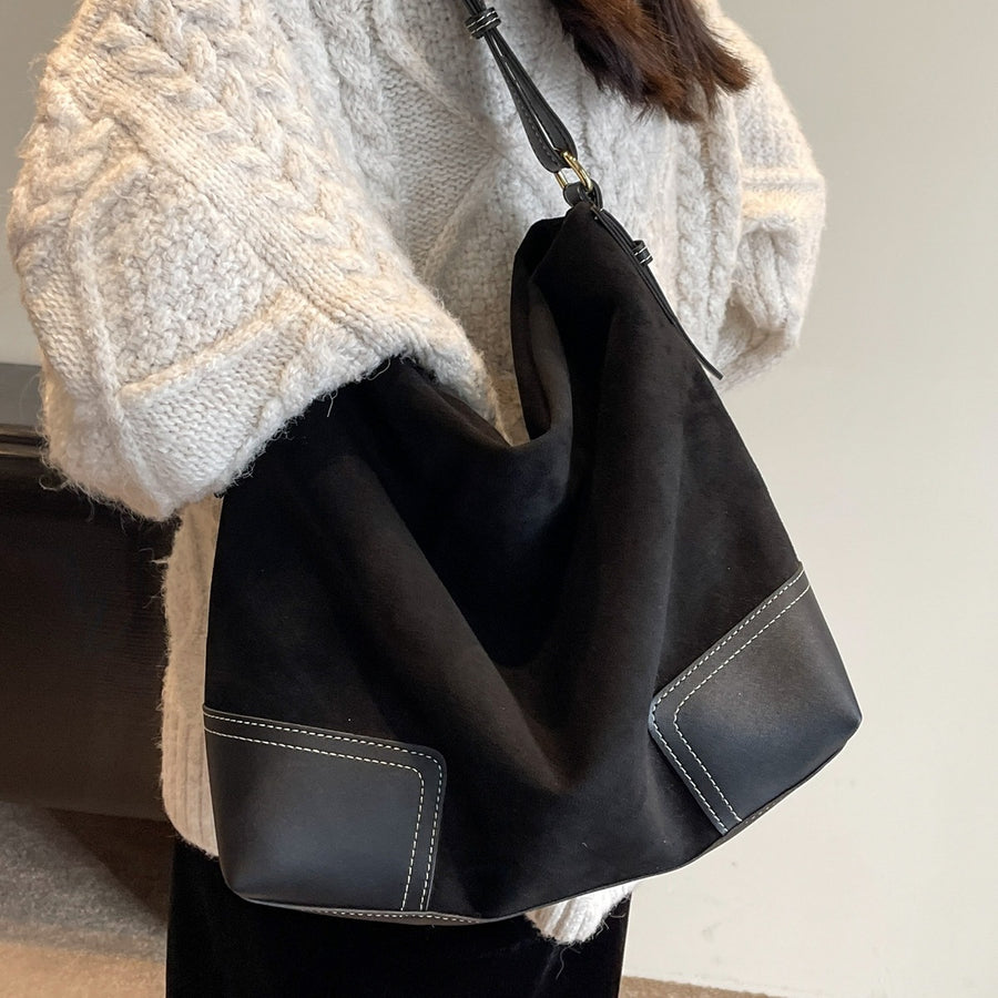 brown handbag featuring patchwork construction and patchwork