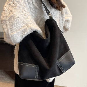 brown handbag featuring patchwork construction and patchwork