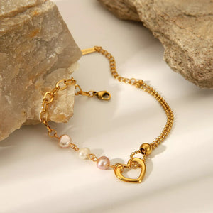 bracelet in gold featuring heart charm and layered fit