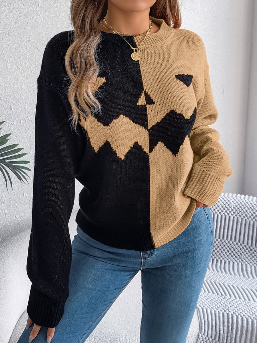 Split-face pumpkin knit sweater in black and camel with crew neck and long sleeves.