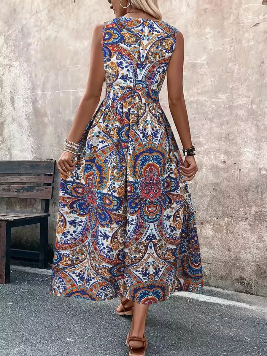 Multicolor paisley print maternity swim dress with cinched waist and sleeveless design.