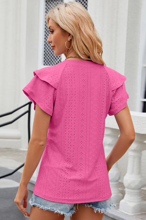 Eyelet flutter sleeve blouse in hot pink with textured fabric and ruffled shoulders.