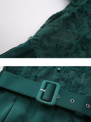 Green lace-embellished maxi dress with lantern sleeves, featuring a zipper and belt detail.