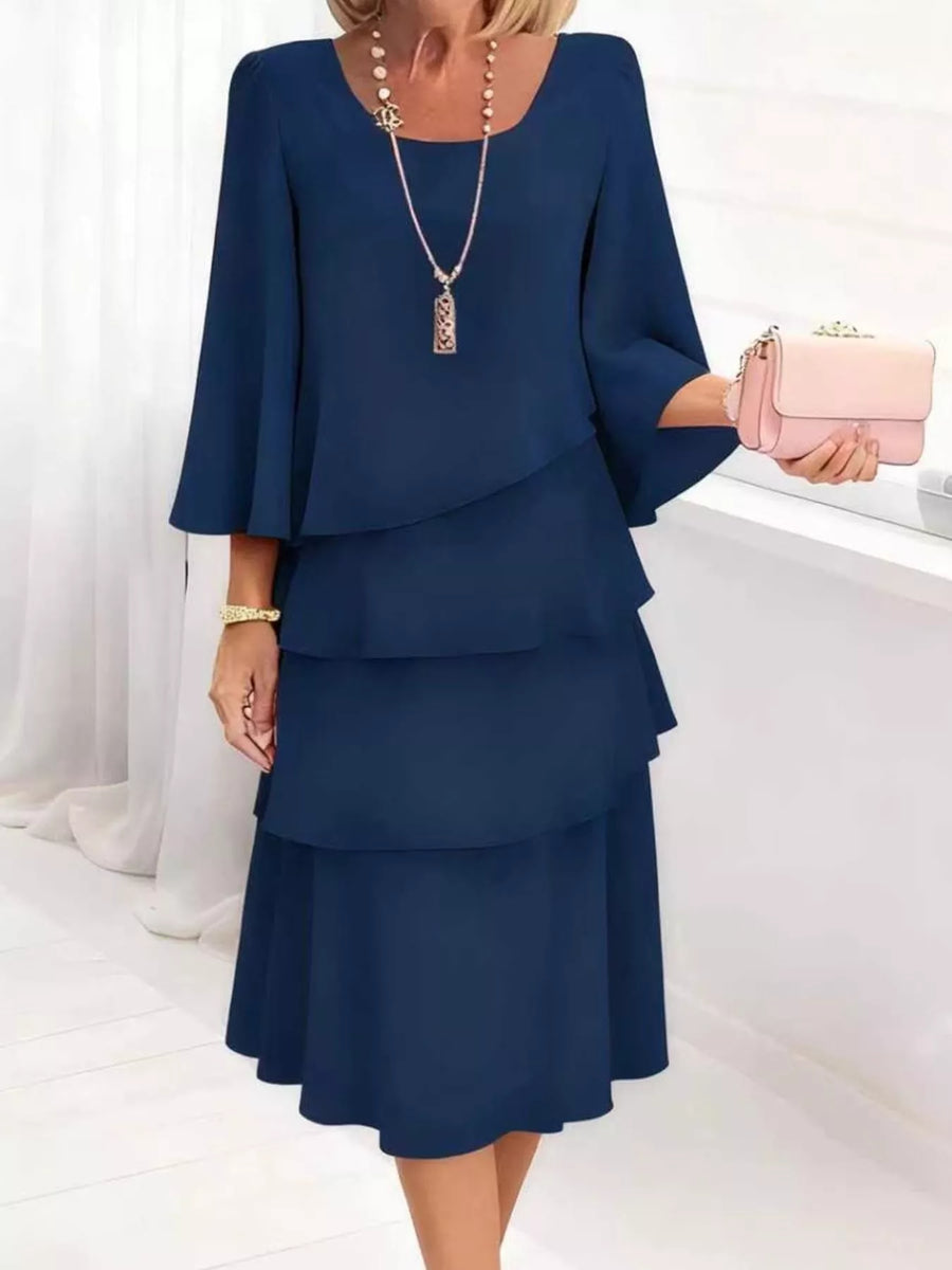 Dark blue tiered dress with 3/4 bell sleeves and a scoop neck.