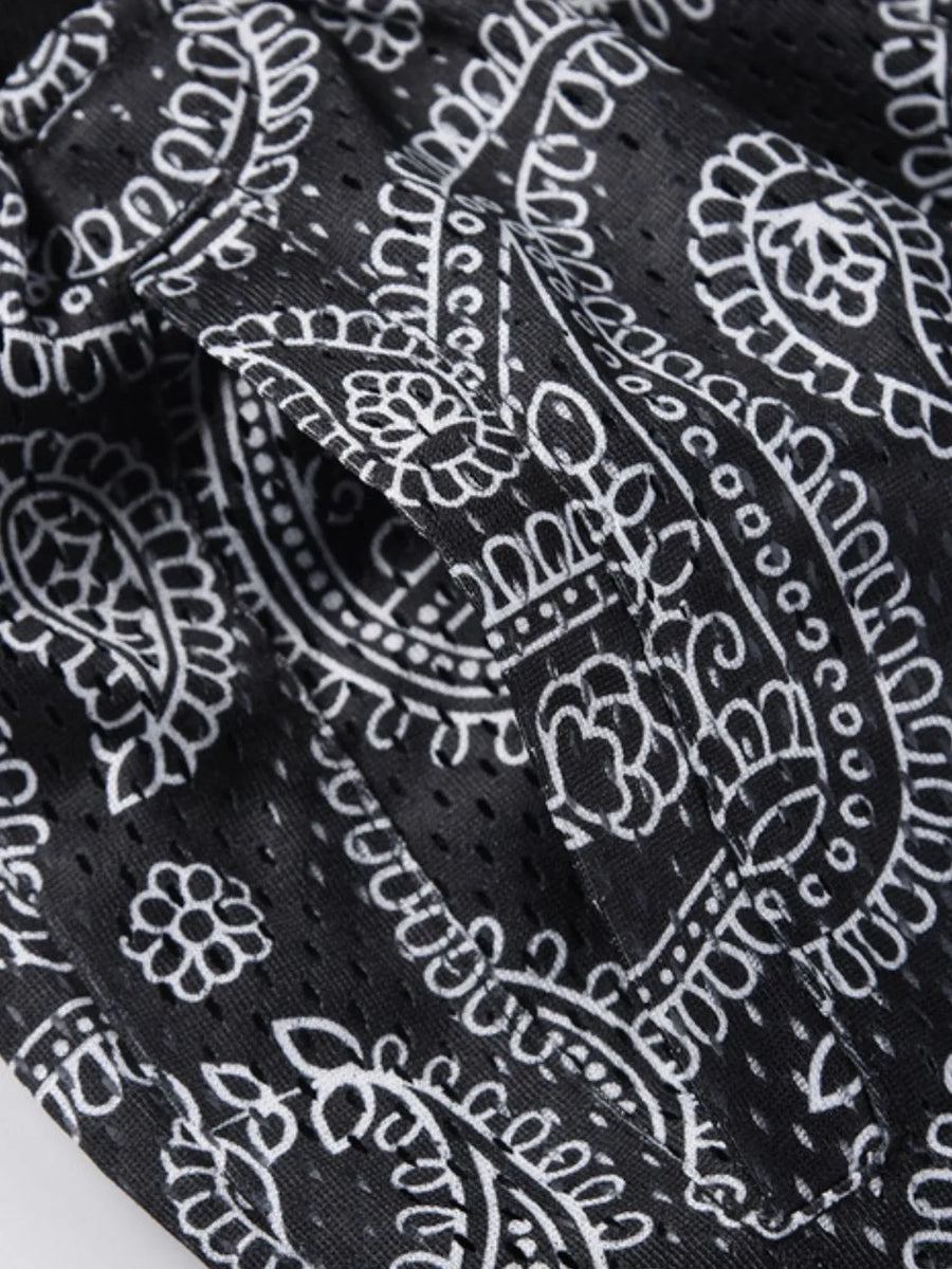 Black paisley mesh basketball shorts with a pocket detail.