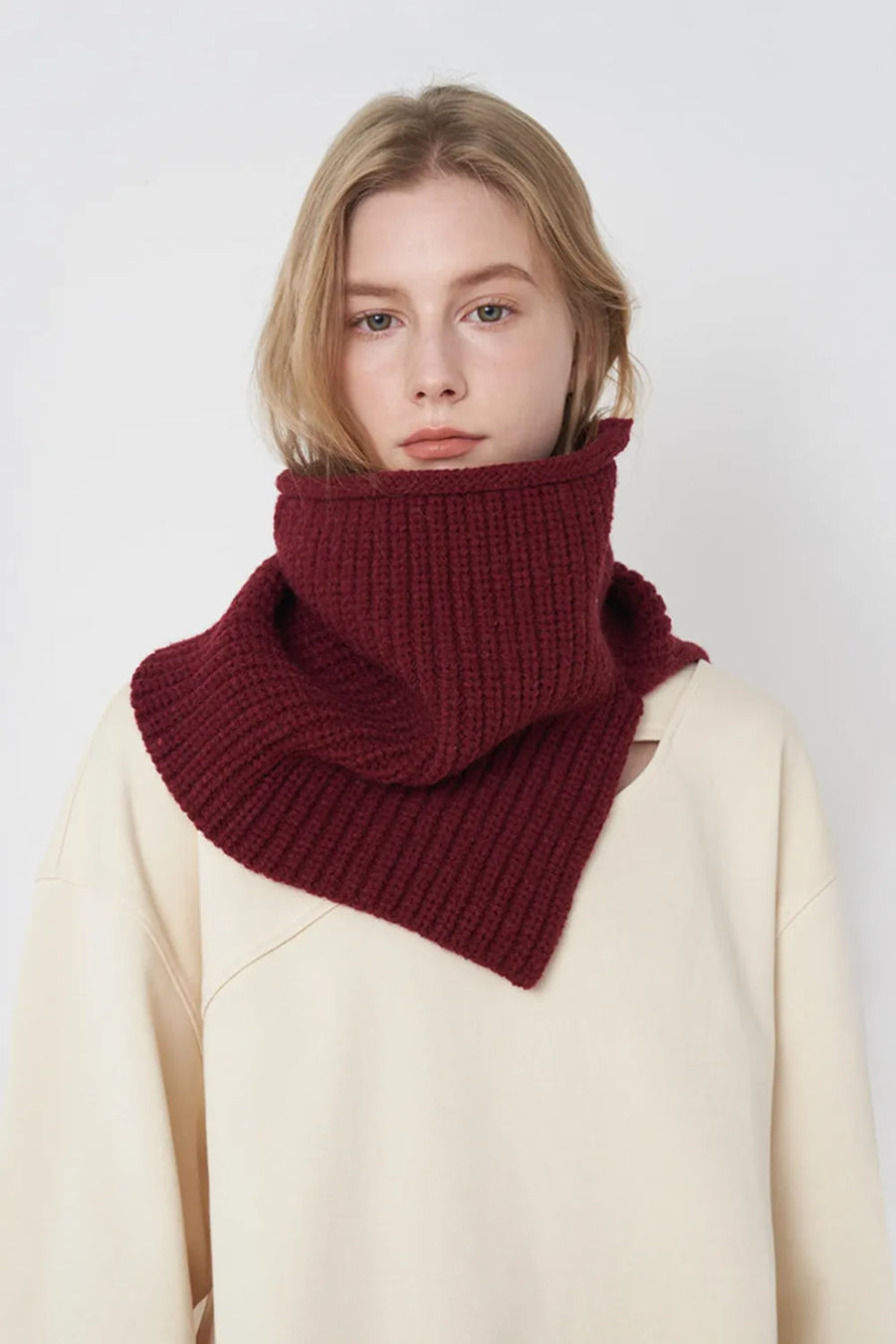 Burgundy ribbed knit neck warmer with extended panel, worn by a model.