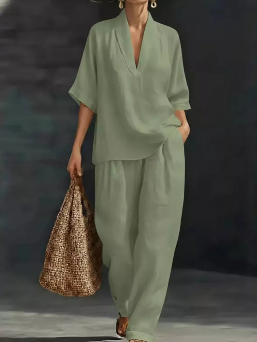 Light green half-sleeve top and wide-leg pants set with V-neck, worn by a woman carrying a straw bag.