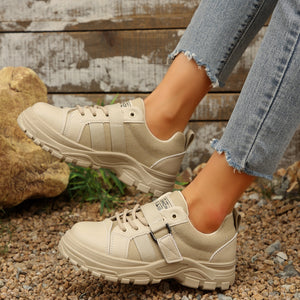 Beige lace up platform casual sneakers with chunky soles and strap detail.