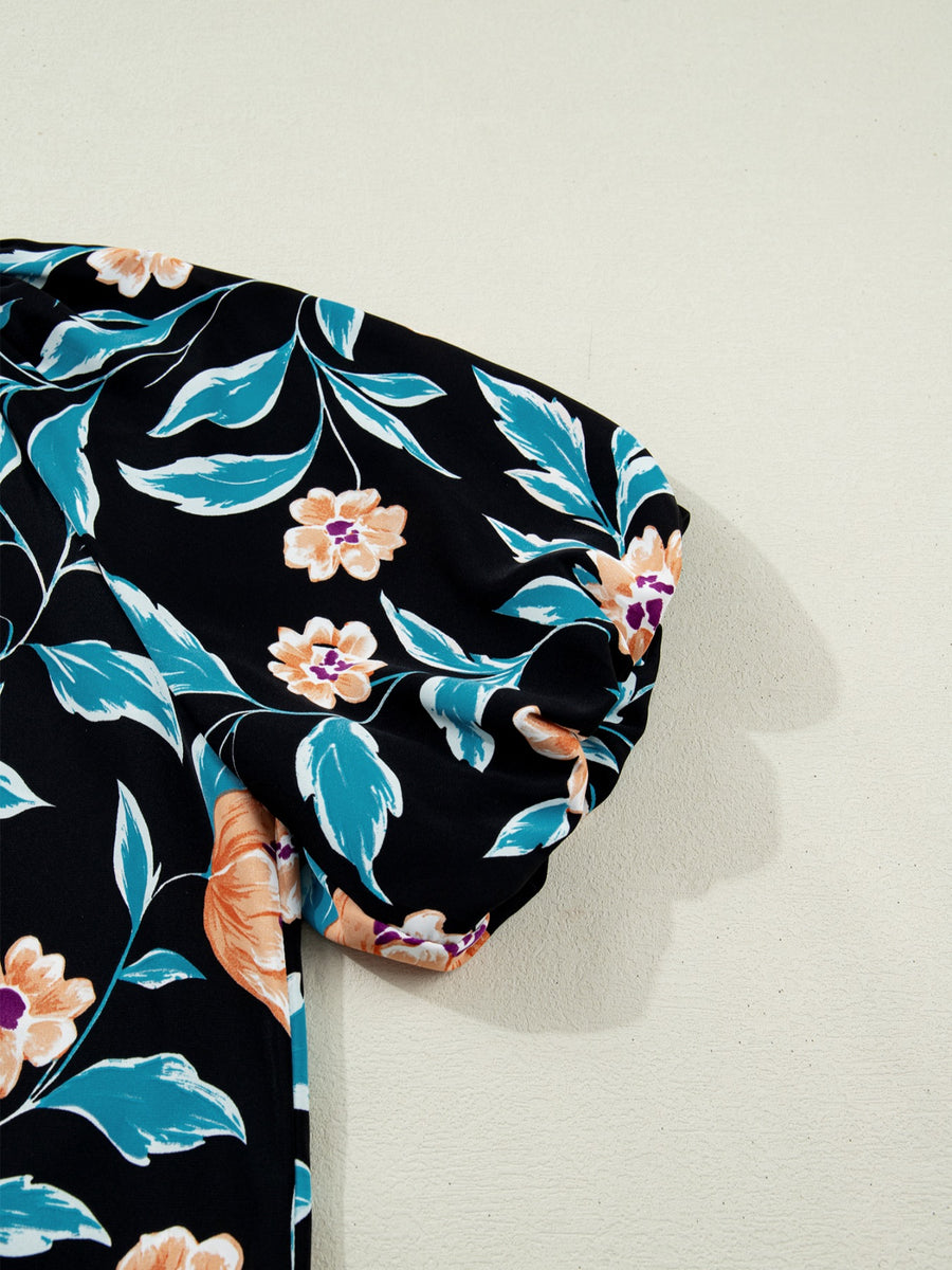 Black floral print bubble sleeve blouse with orange and teal accents.