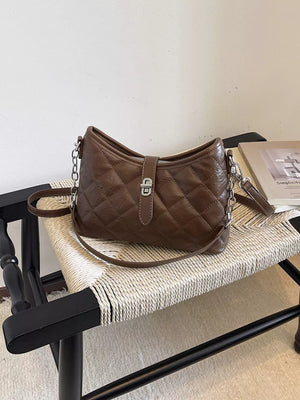 crossbody bag in chocolate brown featuring quilted design and structured fit