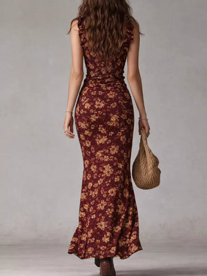 Burgundy floral ruched maxi dress with ruffled straps and a fitted silhouette.