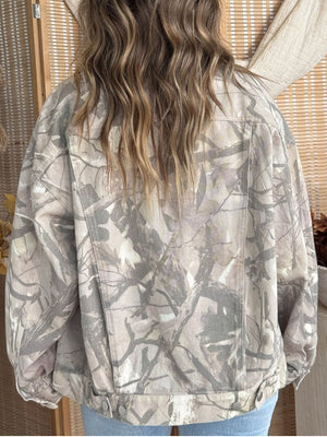 off-white denim jacket featuring buttoned and camouflage