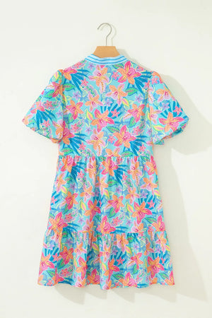 Tropical floral print tiered dress with short sleeves and a v-neck.