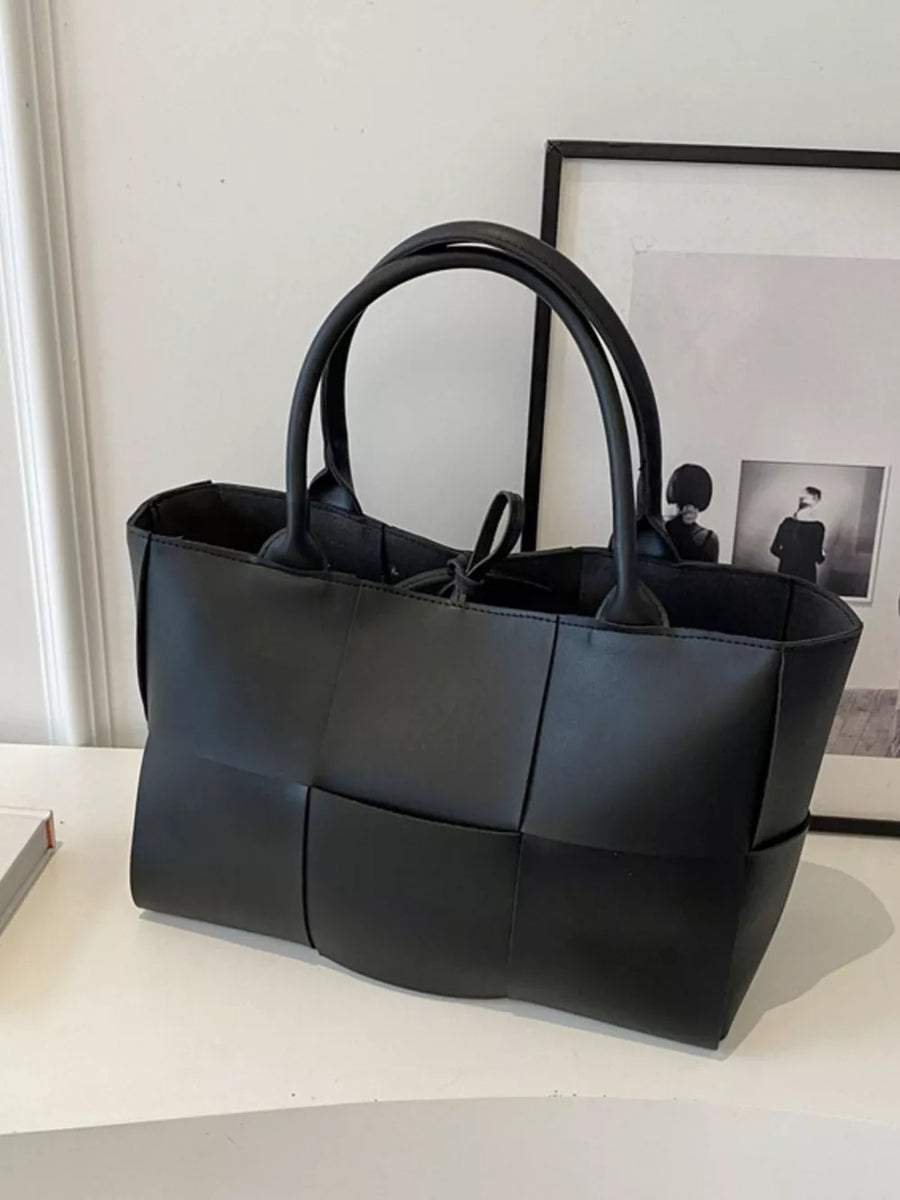 Black woven pu leather large tote bag with dual handles and tie closure.