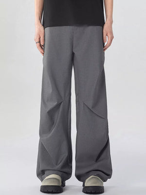 Oversized wide-leg cargo sweatpants in dark gray with unique paneling detail.