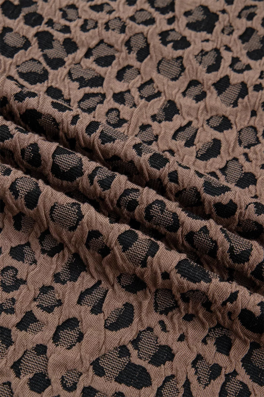 Brown jacquard shirt with black leopard print texture, half-zip neckline detail.