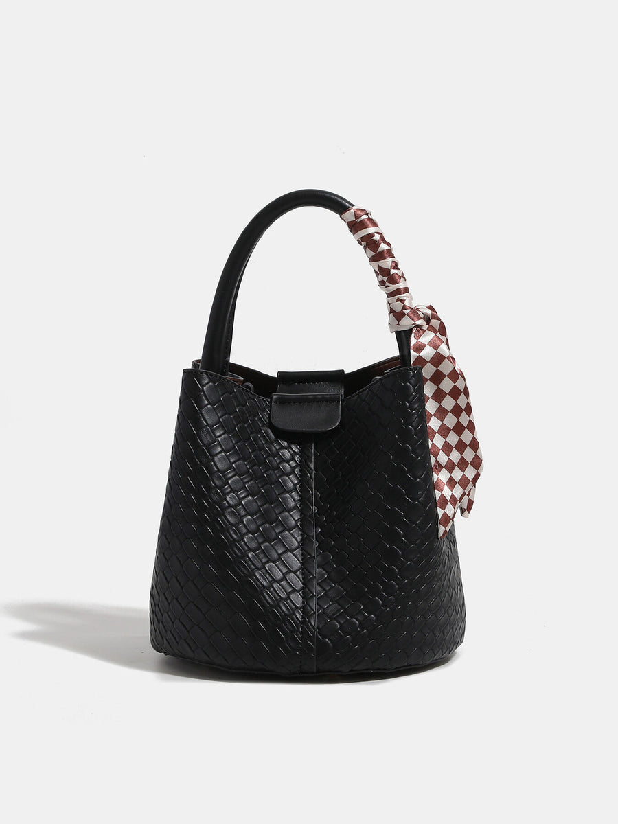 Black handbag featuring woven texture and woven