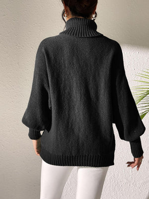 Black turtleneck sweater with dolman sleeves and ribbed cuffs.